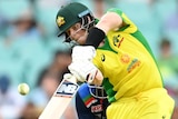 Australia batsman Steve Smith hits a ball down the ground through the air in the second ODI against India.