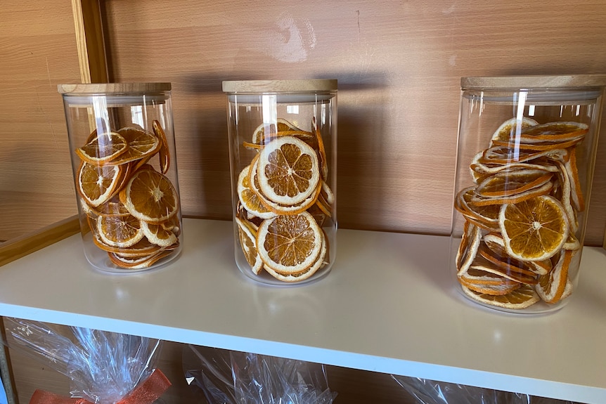 Sliced dried oranges in jars.
