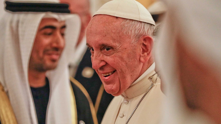 Pope Francis smiles upon his arrival at the Abu Dhabi airport, United Arab Emirates.