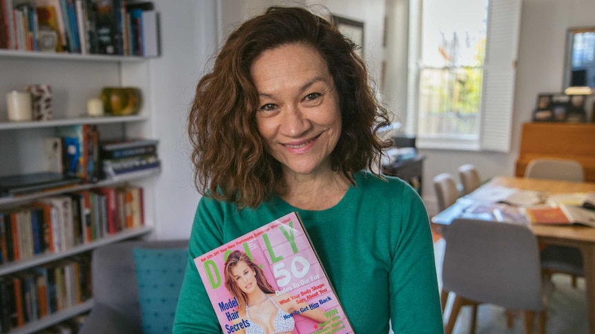 Doctor holding a copy of Dolly mag