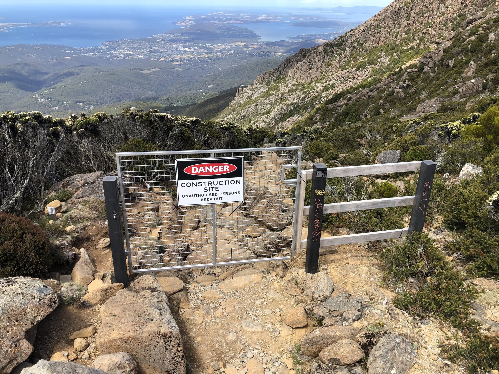 Gate closed at start of mountainous walking trail.