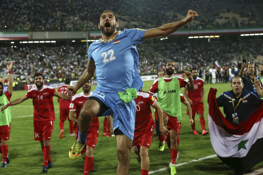 Syrian players celebrate after progressing towards the World Cup finals.