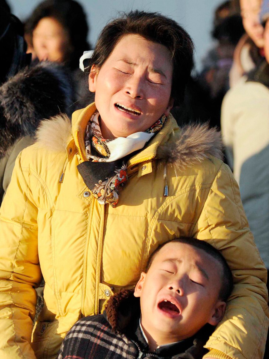 A woman and her son cry as they mourn the death of North Korean leader Kim Jong-il at a square on Mansu Hill in Pyongyang.