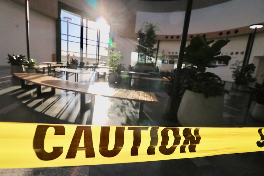 Photo of caution tape blocking off a dining area.