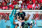 Australia's goalkeeper Mathew Ryan jumps amid a pack of players to catch a ball