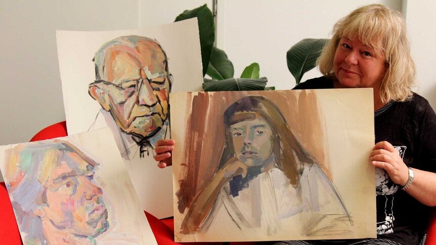 Charlotte Bunt with three of her mother's portraits