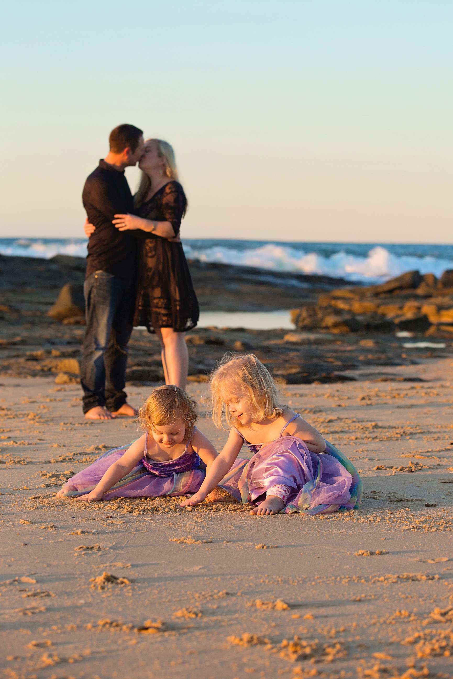 Nicole on the beach with her husband and two children