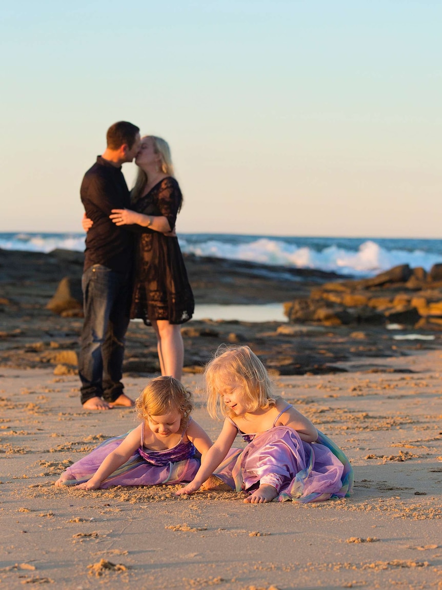 Nicole on the beach with her husband and two children