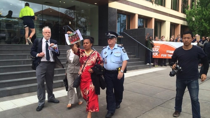 Climate change activists are arrested for trespassing outside the Minerals Council of Australia in Canberra.