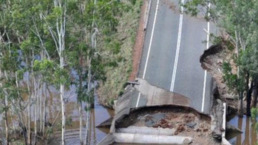 Floodwater damages the Leichhardt Highway between Banana and Theodore in Queensland in January 2011.