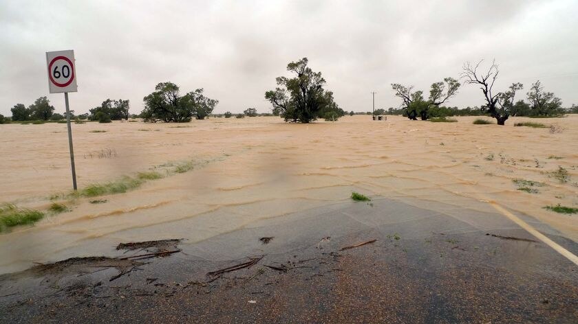 A road sign is all that can be seen on a flooded Birdsville road.