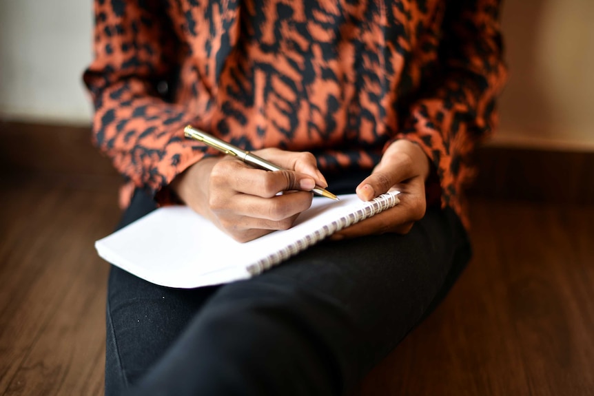 Woman writing on a note pad