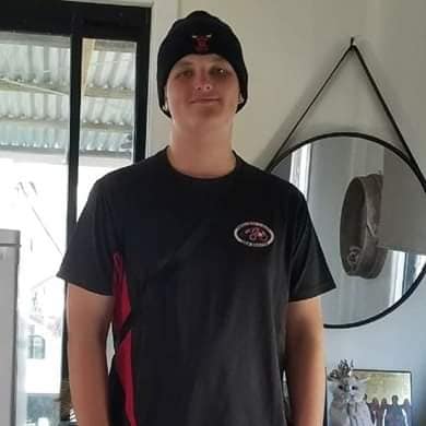 Angus Beaumont who was stabbed to death in a Redcliffe park, smiling and wearing a beanie