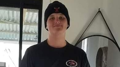 Angus Beaumont who was stabbed to death in a Redcliffe park, smiling and wearing a beanie