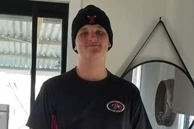 Angus Beaumont who was stabbed to death in a Redcliffe park, smiling and wearing a beanie