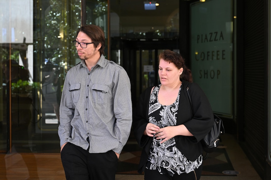 One man, Anthony Mitchel and a woman, walk out of a Sydney court