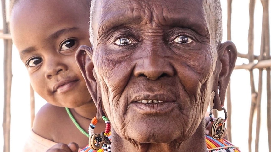 Ngamasioi Lembwakita, one of the eldest members of Unity Village, holds baby Latrice.