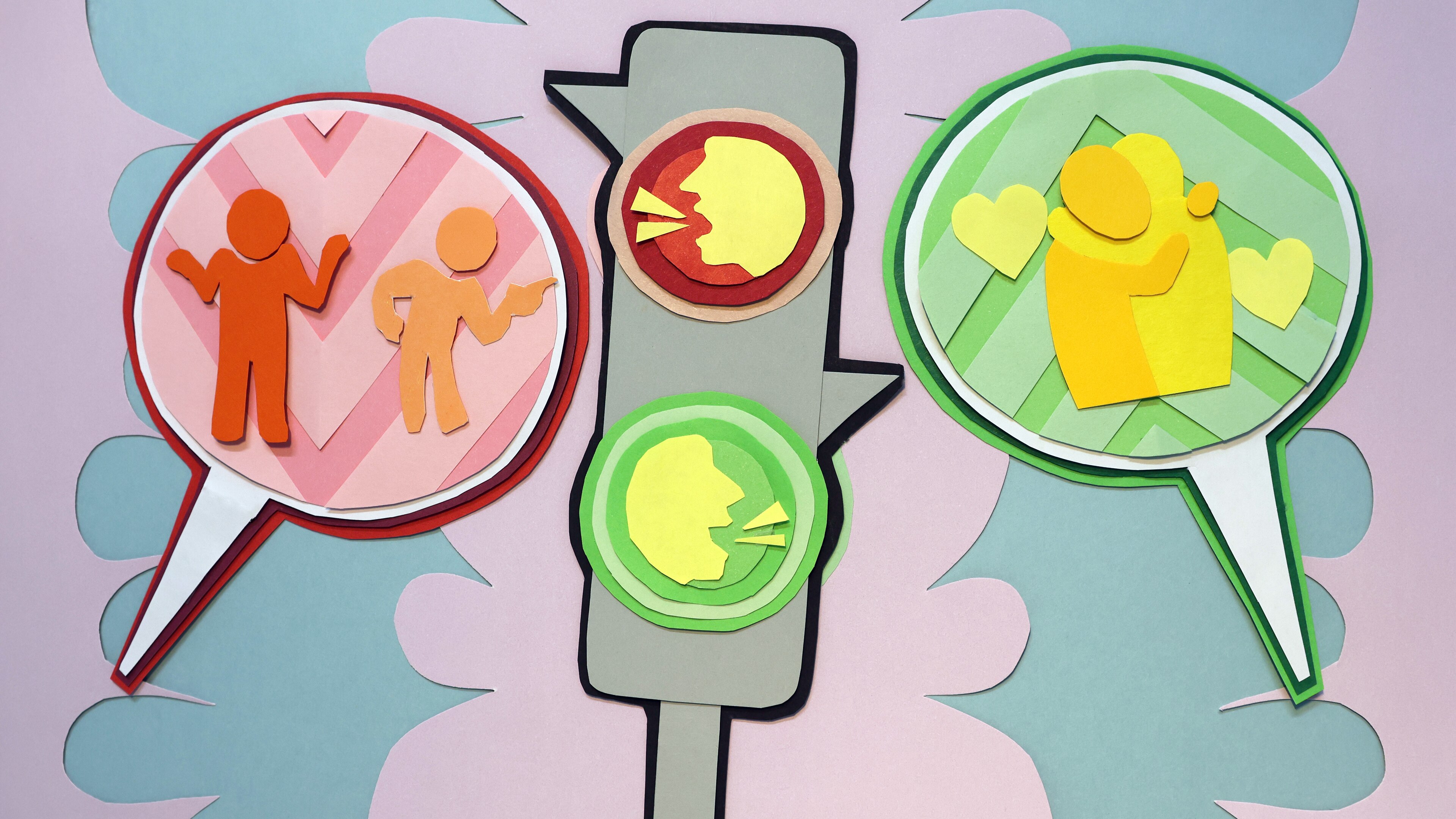 An artwork of a traffic light with a red and green light. One speech bubble shows two people and another shows two hugging.