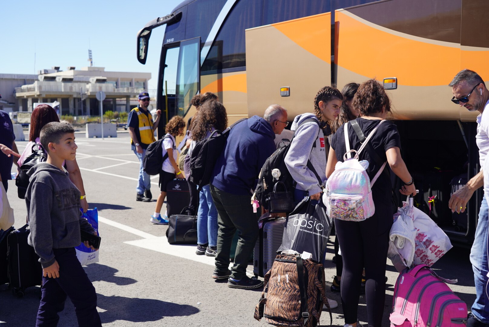 People load luggage on to a bus taking them to accomodation in Cyprus.