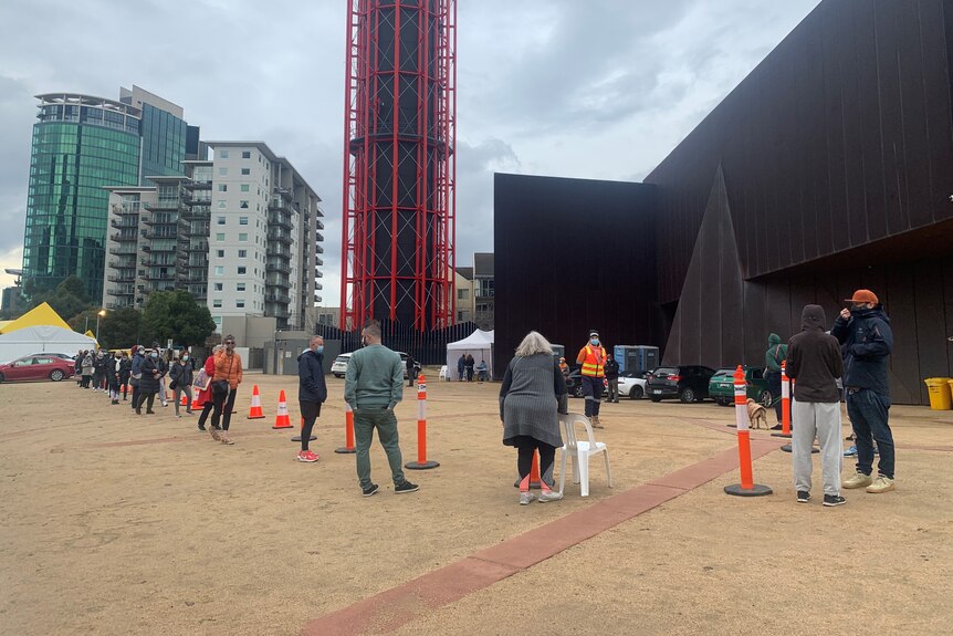 People line up at a testing site.