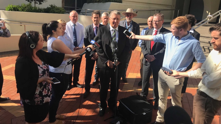 The Tamworth Mayor Col Murray, surrounded by councillors, addresses a press conference in Tamworth.