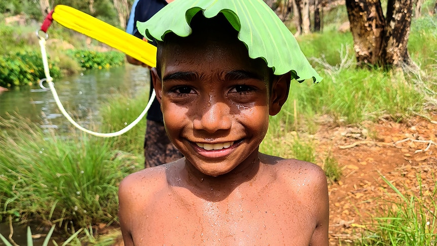 A boy stands by the river at Warmun, 2021.