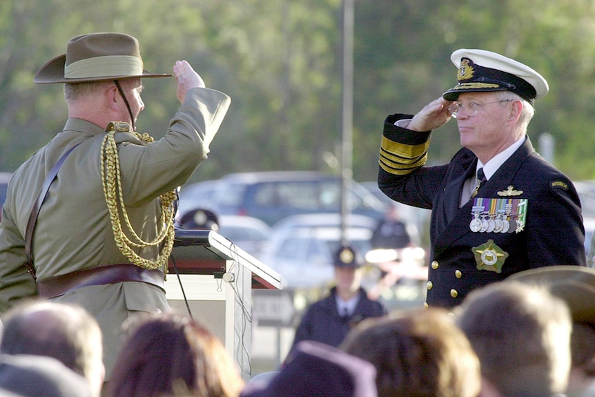 In full dress saluting to each other.