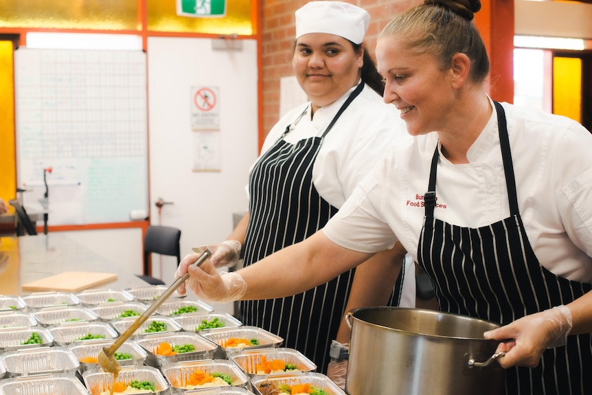 Women at Bungala Food Service serving meals. 