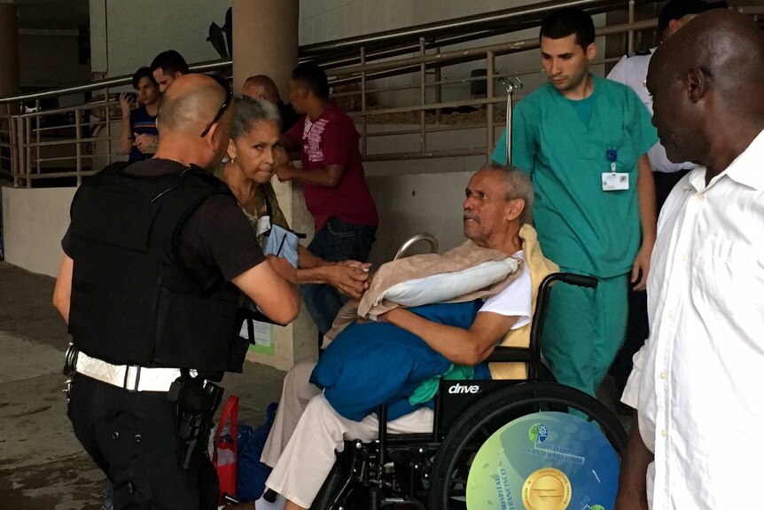 A patient is moved in a wheelchair from San Francisco Hospital.