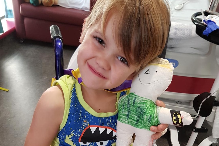 Jett Burgess with a toy in hospital.