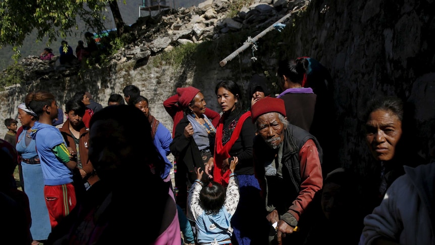 Quake survivors wait for aid to be distributed in Dhunche, Nepal