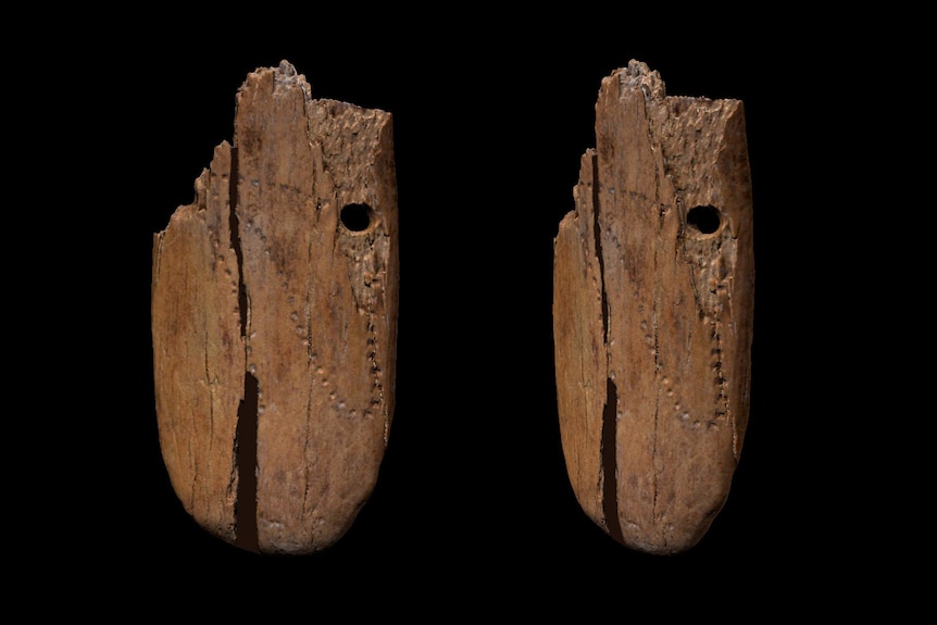 Close up of both sides of an ancient bone pendant