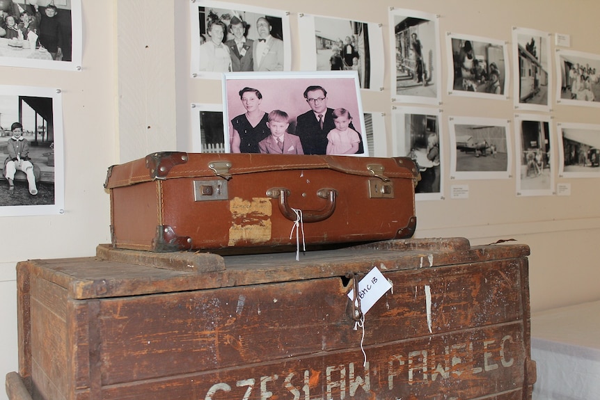 A migrant family photo sitting on top of the original suitcases they used when migrating to the Australia after World War II.