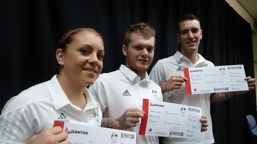 The team pose with mock-up plane tickets to Rio.
