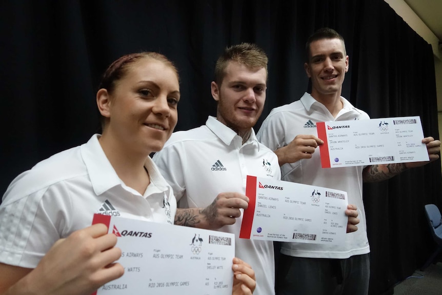 The team pose with mock-up plane tickets to Rio.