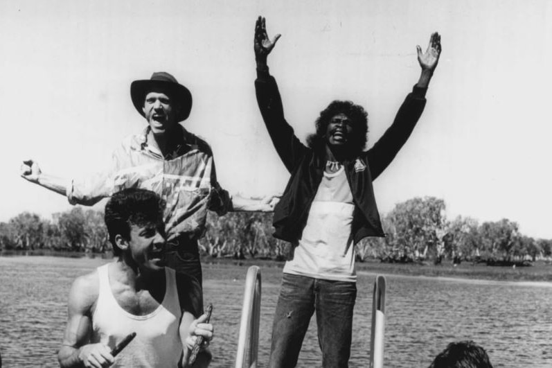 Midnight Oil and the Warumpi Band performing on the South Alligator River at Kakadu during the Blackfella/Whitefella Tour.