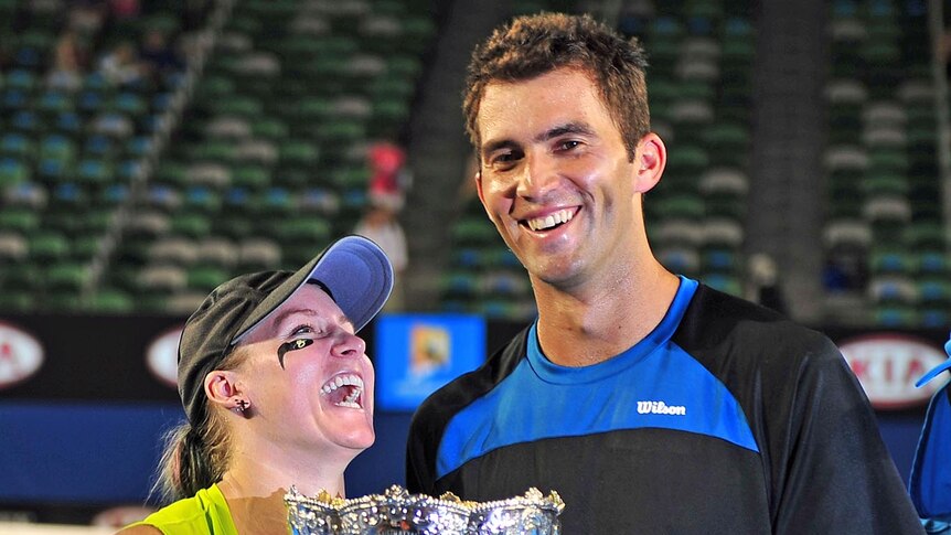 Horia Tecau and Bethanie Mattek-Sands pose with the trophy after winning the Australian Open mixed doubles on January 29, 2012.