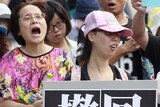 Activists march in front of Taiwan's education ministry