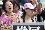 Activists march in front of Taiwan's education ministry