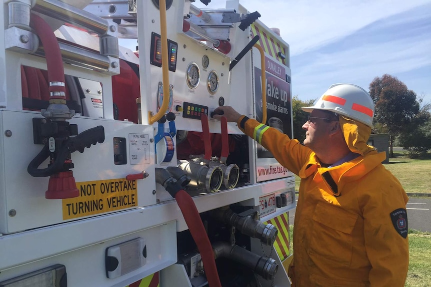 A firefighter inspects a new TFS truck