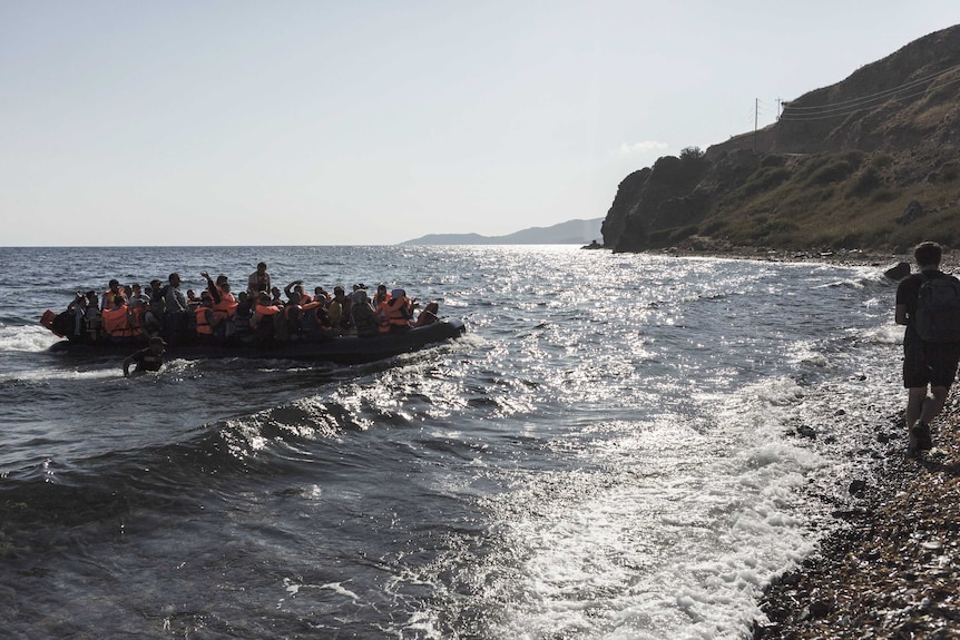 An inflatable boat with Syrian refugees approaches the coast of Lesbos, Greece