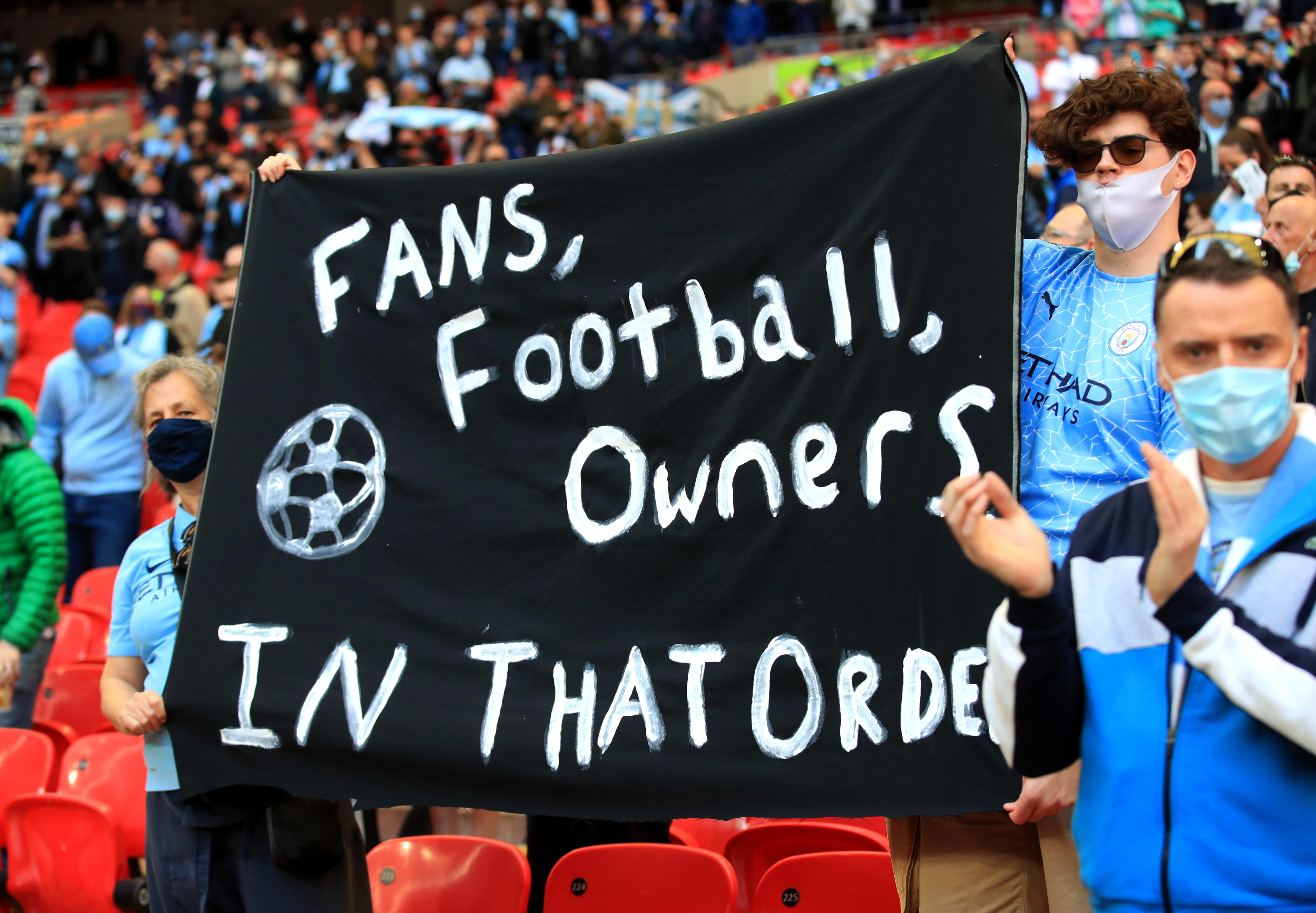 Soccer fans hold up protest banners