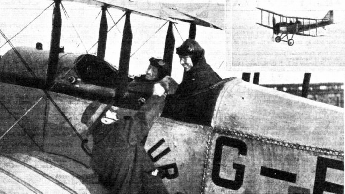 A black-and-white image of a man shaking the hand of a pilot in a biplane.