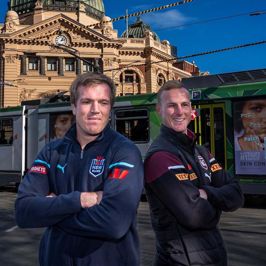 NSW Blues captain Jake Trbojevic and Queensland Maroons captain Daly Cherry-Evans stand in front of Flinders Street Station.