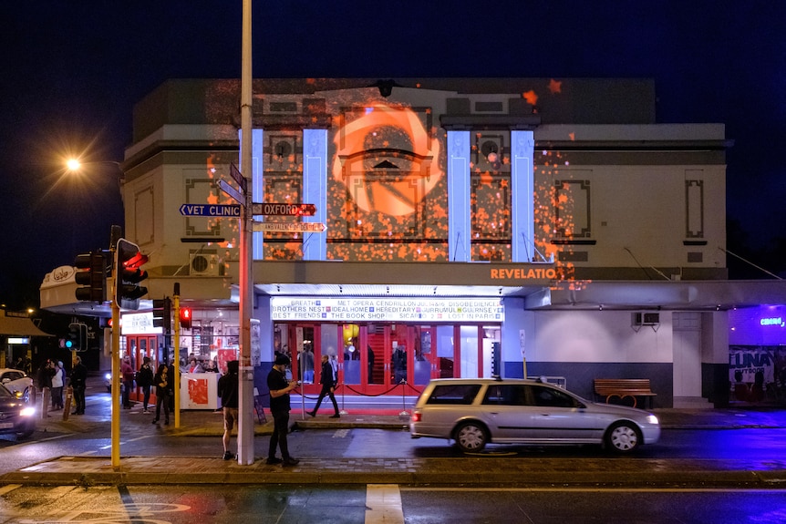 Luna cinema lit up at might time, viewed from the street.