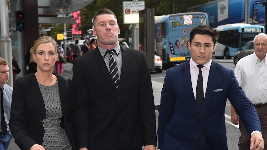 Shaun Kenny-Dowall walking outside the Downing Centre Local Court with two other people.