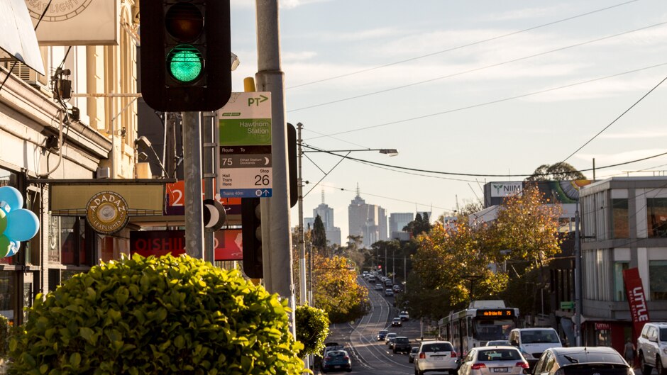 Inner suburban main street, city in background.