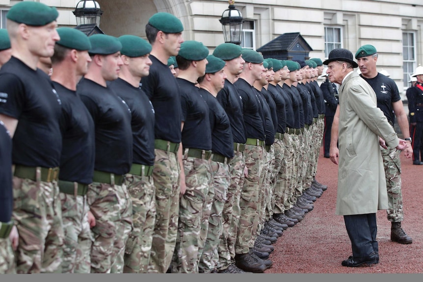 Prince Phillip speaks to a line of marines outside Buckingham Palace.