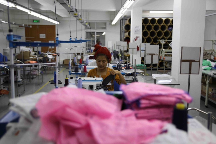 A woman sews on a machine