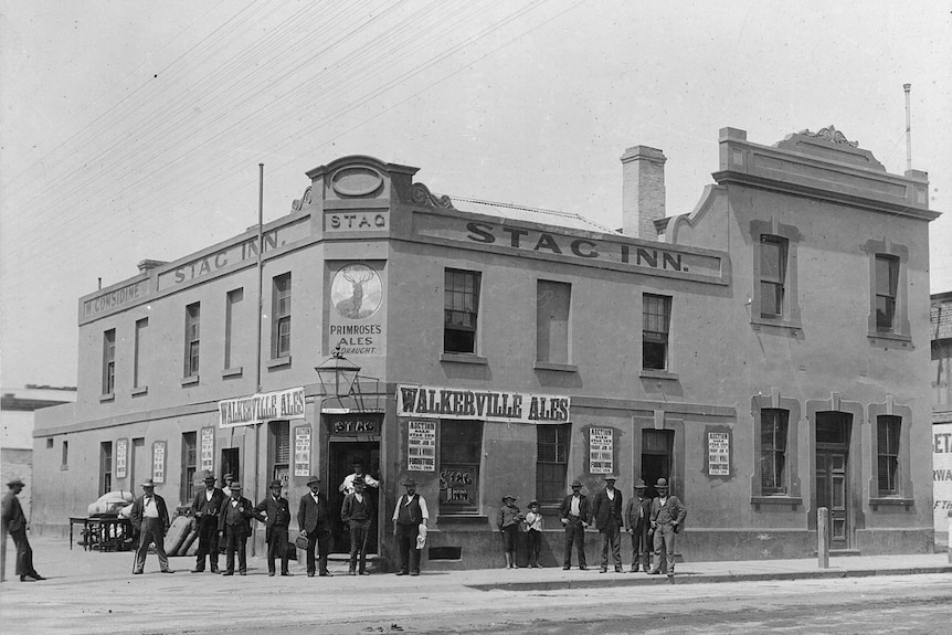 A group of men stand outside the Stag Inn.